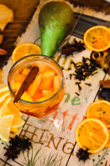 mulled wine with spices on wooden background
