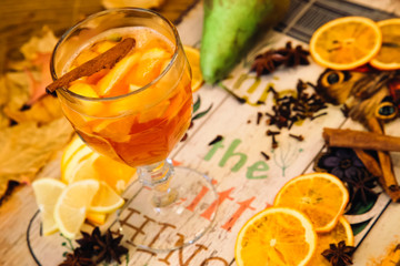mulled wine with spices on wooden background