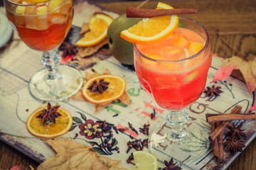 mulled wine with spices on wooden background