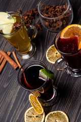 mulled wine with spices on wooden background
