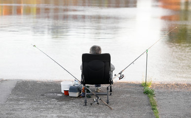 the fisherman at the pier is fishing.