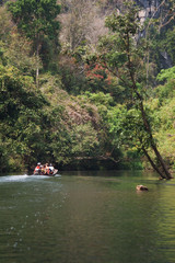 Fototapeta na wymiar Boat trip on a river in Laos near the mountains