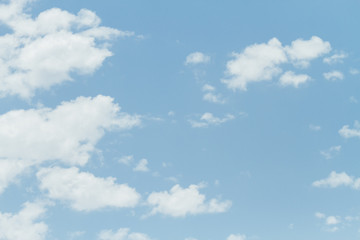Several small clouds against blue sky
