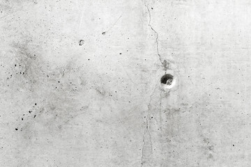 Close-up of concrete wall texture with a hole