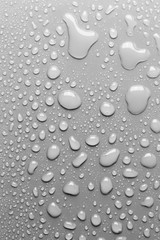 Surface with water drops, grey background