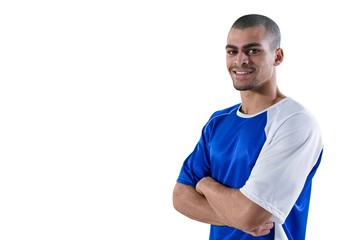 Portrait of football player standing with arms crossed