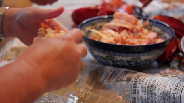 People prepare lobster for dinner
