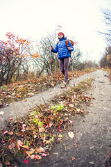 Fototapeta premium A girl with trekking sticks.