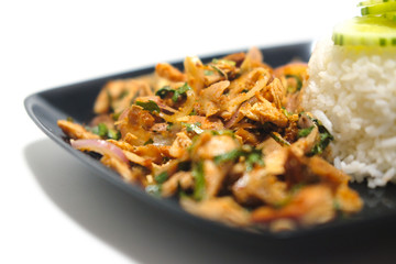 Spicy roasted chicken with rice in black dish