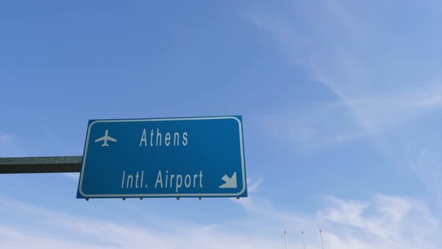 athens airport sign airplane passing overhead