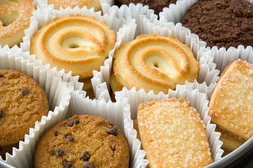 Assorted butter cookies in box on wooden table
