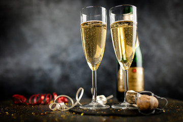 Two champagne glasses in golden glitter
