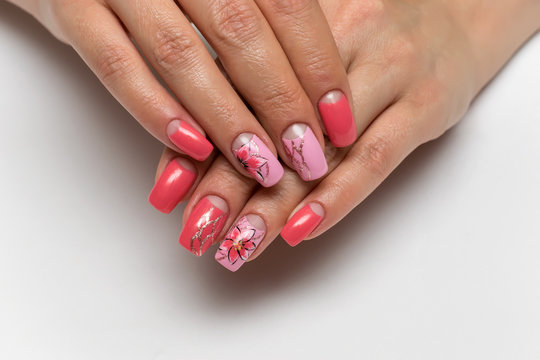 Delicate pink manicure with painted flowers and golden cobweb on long square nails
