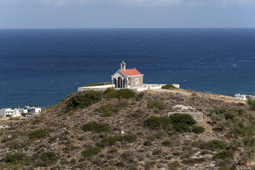 Fototapeta na wymiar Greek chapel on a hill facing the Cretan Sea near Sisi a small seaside resort. Crete, Greece. October 2017