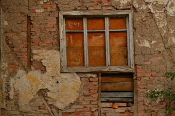 wooden window frame on old building. bricks, wood and window on village house. retro architecture.