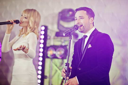 Musicial music live band performing on a stage with different lights.