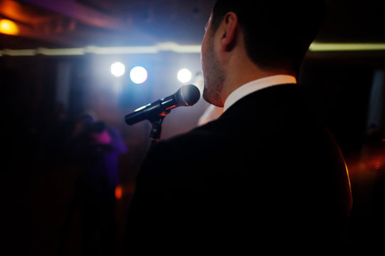 Musicial music live band performing on a stage with different lights.
