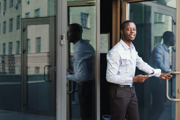 Portrait of a confident young black businessman with papers