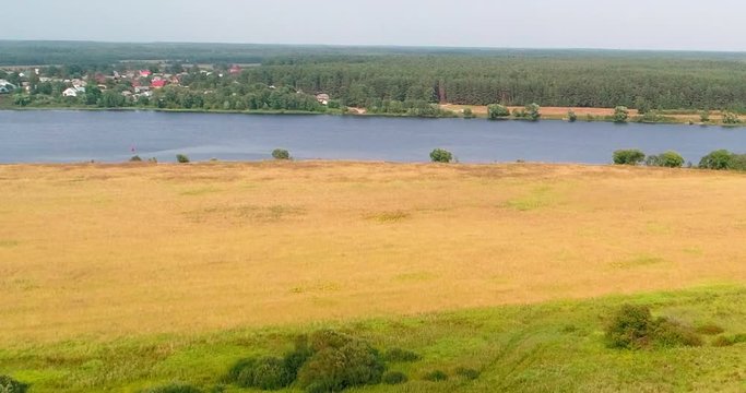Arable landon Volga river aerial view from flying quadcopter over forest. Landscape panorama. Beautiful nature. Horizon in the background of fields of meadows and sky.
