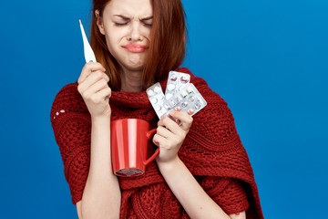sick woman, thermometer, tablets, mug, blue background