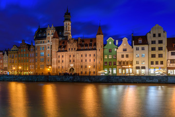 View of Gdansk's old Town and Brama Mariacka (Maria's Gate) from the Motlawa River at night. Poland, Europe.