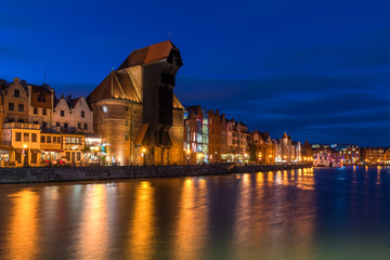 Fototapeta na wymiar Famous old port crane of Gdansk and Motlawa river at night. Poland, Europe.