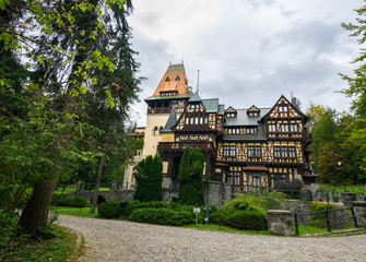 The outstanding royal residence The Peles Castle and its surrounding on a gloomy day, Sinaia, Bucegi National Park, Southern Carpathians Mountains, Transylvania, Romania