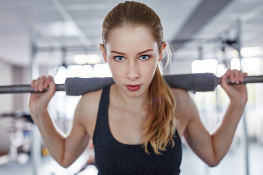 Portrait of young woman working out in the gym