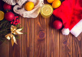 Tea with lemon on a wooden table with citrus fruits, orange, mandarin and garat. Ingredients for a Christmas drink
