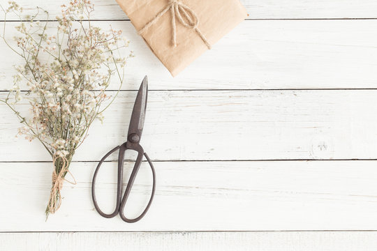 Flat lay photo of wood table,white copy space with scissors top viewt