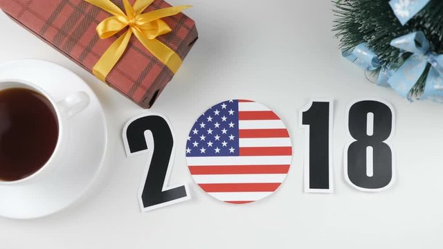 Illustration, new year, male hand put on the table an United States of America flag, cauntry ball, 2018
