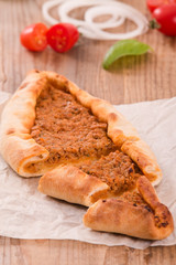 Turkish pide pizza with meat and onion. 