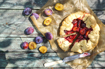 Fresh, fragrant pie from plums on an old, shabby table
