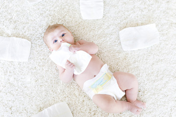 newborn baby girl with diapers. Dry skin and nursery