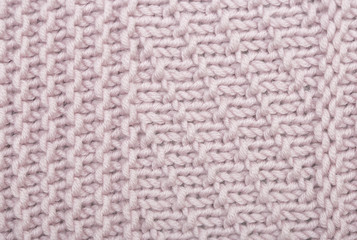 Sweater or scarf texture large knitting. Knitted jersey background with a relief pattern.  Wool hand-knitted or machine knitting pattern. Fabric Background.