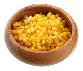 Corn seeds in a wooden bowl isolated on white background. Top view.