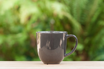 Coffee mug on wooden table.