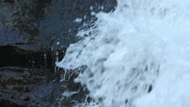 Waterfall details with water trickles and splashes on the stone and (1080p, 25fps, sound)
