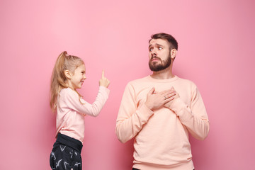 Young father with his baby daughter. The kid in preschool age pointing with finger