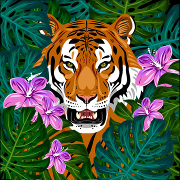 Portrait of a tiger in green undergrowth and flowers