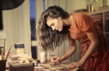 Beautiful young woman painting