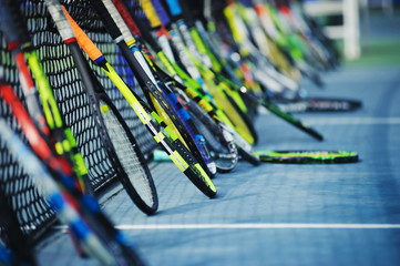 tennis rackets or tennis racquets leaning against tennis court background