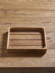 empty fruit crate behind wooden table