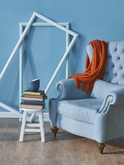 decorative blue living room with sofa and empty frame decor