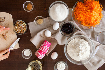 Baking ingredients on kitchen table. Products for filling carrot cupcakes prepare for cooking on wooden cutting board. Lifestile food concept.