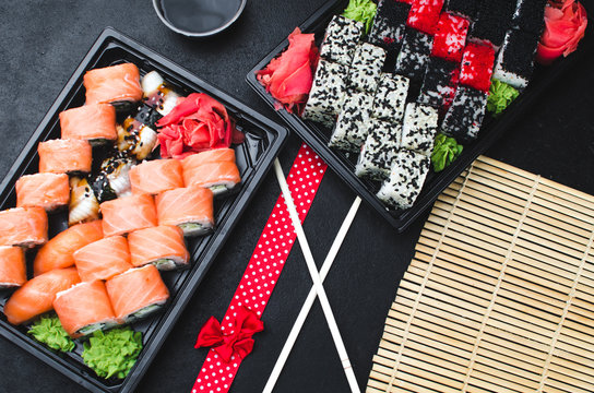 Sushi in a black container on a wooden table colorful and beautiful