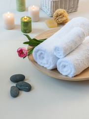 Obraz na płótnie Canvas white towel candle and grey rock design spa center concept