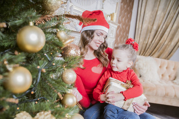 Fototapeta na wymiar Christmas mother and daughter with Christmas tree