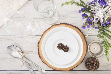 Dinner plate setting on wood table top view.