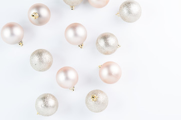 Rose gold Christmas decorations on a white background